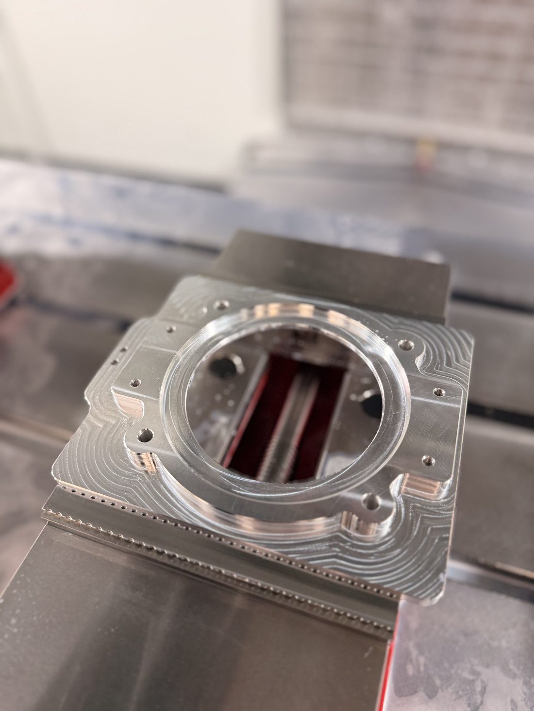 Freshly machined aluminum part in the mill vise