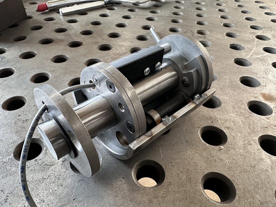 Machined roller assembly with shaft and flanges