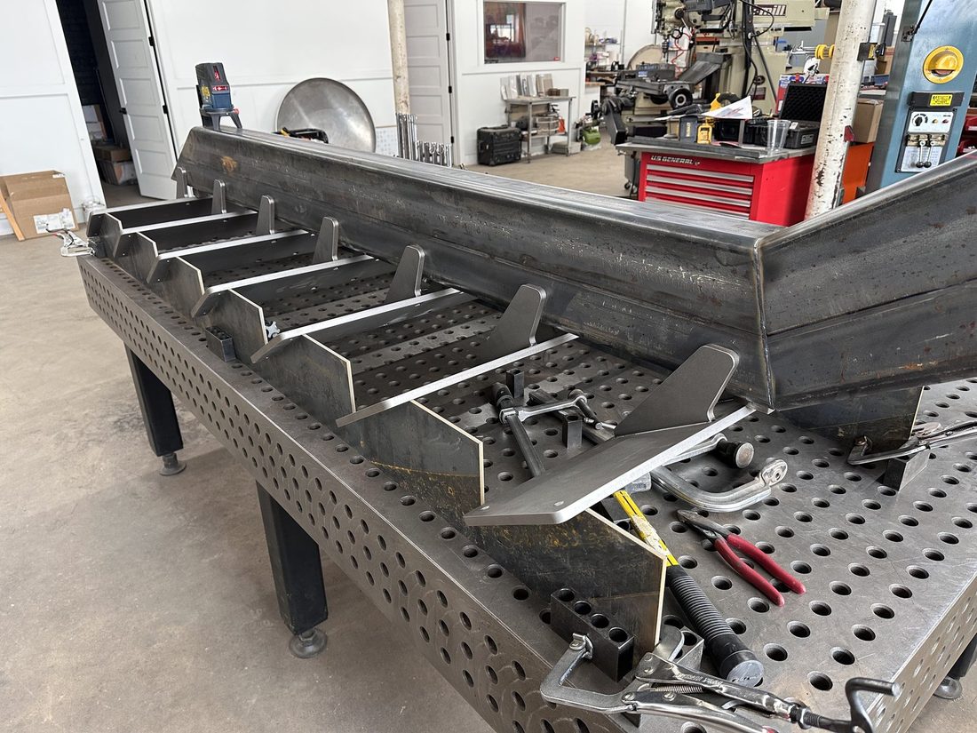 Welded steel assembly fixtured on a precision table